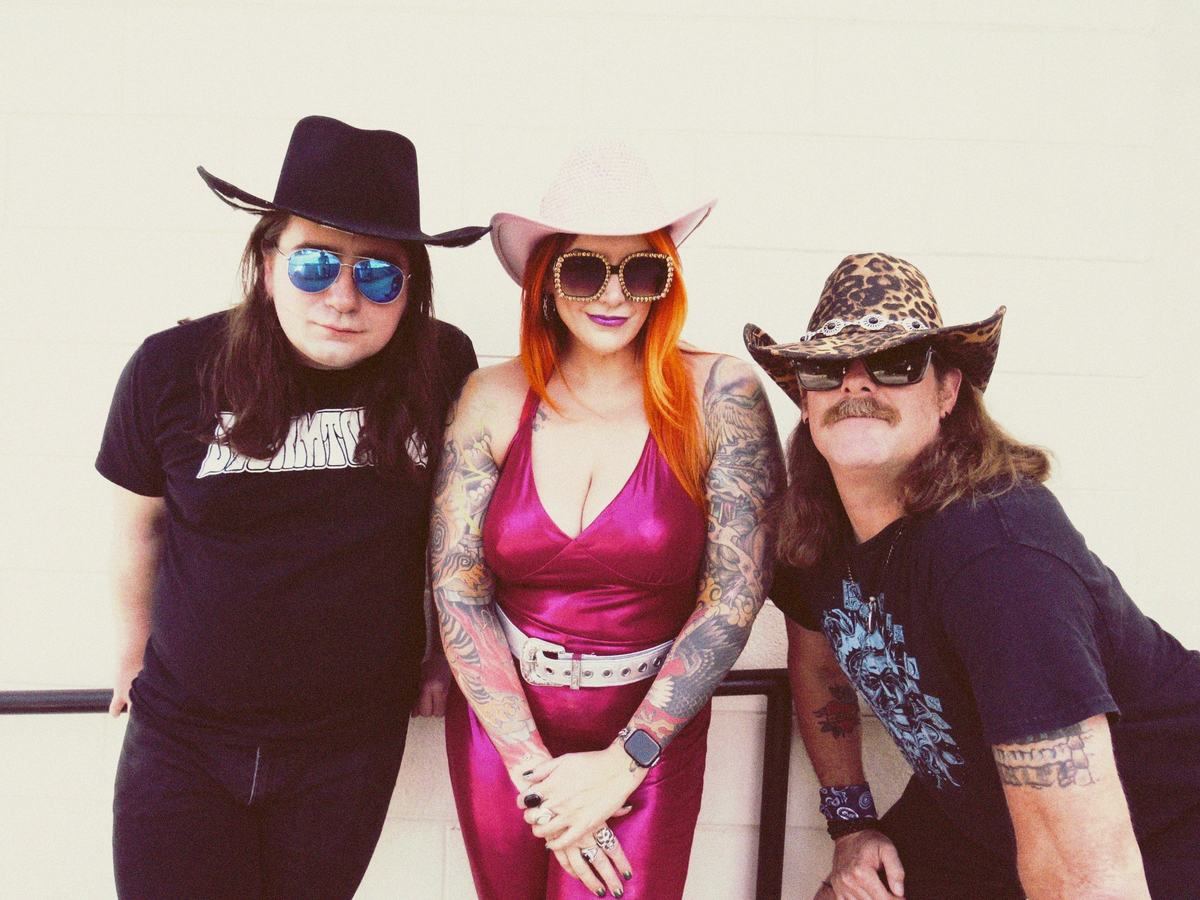 Kevin See, Brenna Leath, and Aaron Willis leaning over a railing